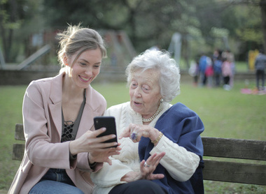 young lady showing phone to old lady.jpg