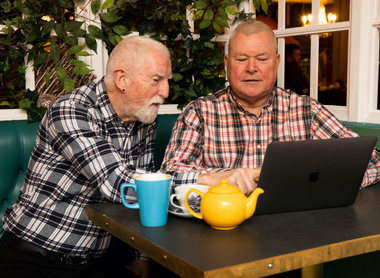 two men looking at a laptop.jpg